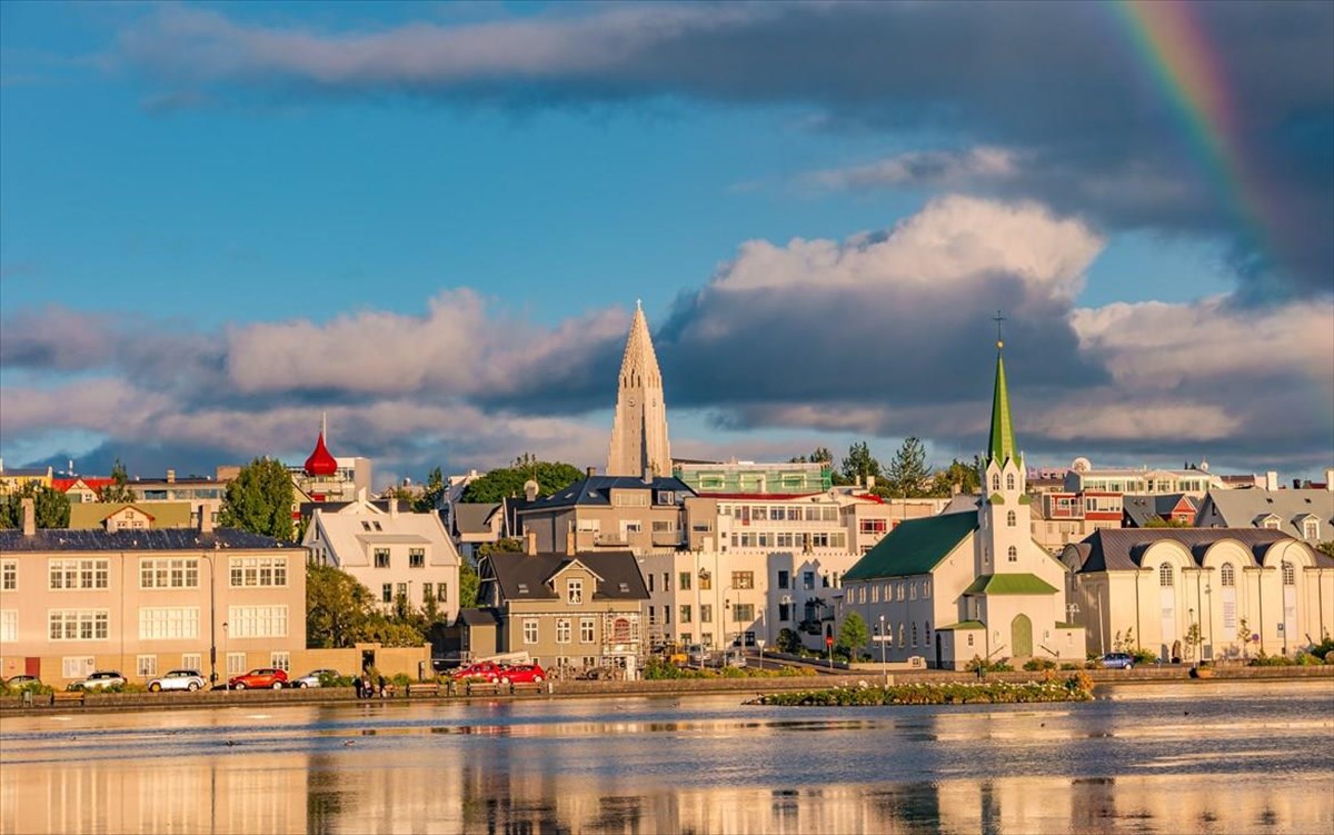 historicalandtouristicdowntowninreykjavikatsunsetandrainbow